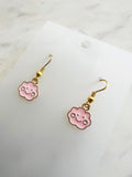 Pink cloud shaped earrings on a marble background