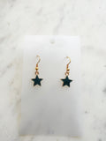 Star shaped earrings on a marble background