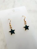 Star shaped earrings on a marble background