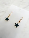 Star shaped earrings on a marble background