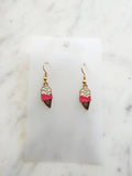 ice cream cone shaped earrings on a marble background