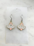 Pair of earrings with moth design on a marble  background