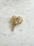 Vintage Gold-Plated Crystal Spray Brooch with  Marquis Center on a marble background