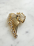 Vintage Gold-Plated Crystal Spray Brooch with  Marquis Center on a marble background