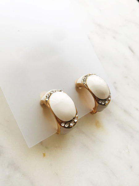 Glam-up your look with these sparkling Gold & White Enamel Half Huggie Clip On Earrings. Boasting an eye-catching design, these huggie earrings will take your outfit to the next level! Make the ordinary extraordinary and add a touch of glamour to your day. Woot woot!  Gold Plated  Clip On   21mm x 11mm