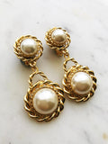 These Rope Double Pearl Earrings are a timeless treasure! Classy and chic, they feature vintage pearl cabochons that will elevate any look. So, put yourself in pearls of wisdom and add some pizzazz to your wardrobe.  Gold Plated  Clip On   65mm x 30mm