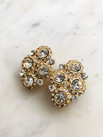 Introducing Harper, the perfect earrings to make your style stand out! These one-of-a-kind, clip-on earrings, with their glimmering crystals, will have you shining like a star (and feeling like one, too!) So, show a little sparkle and strut your stuff!  Vintage Crystal  Gold Plated  Clip on Earrings  43mm x 26mm