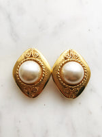 Add some vintage dazzle to your everyday look with these domed pearl clip-on earrings. Magnificently designed, they feature a sleek, classic finish that will make heads turn! These pearls have style that won't ever go out of fashion!  Gold Plated  Clip On   40mm x 30mm